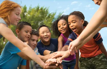 group of kids in a team huddle