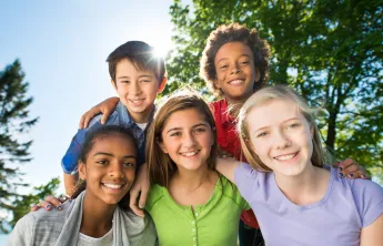 Group of young teens smiling together outside