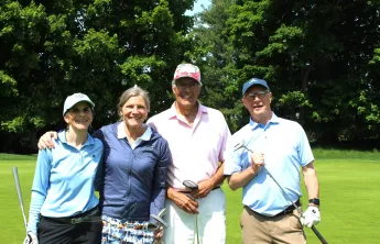 2 ladies and 2 men in a golf foursome smiling together