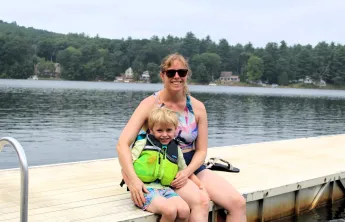 mother and son sitting on dock at Camp Frank A. Day during WSYMCA Family Camp weekend