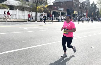 Liz Puleo running the 2025 Boston Marathon for the WSYMCA