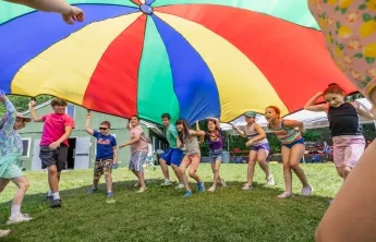 Campers at Camp Chickami playing with the parachute game