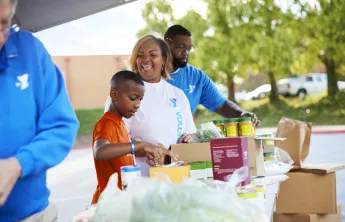 Y volunteers sorting canned food items