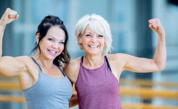 2 Older Adults in workout gear smiling