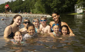 group of campers and swim instructors in the lake