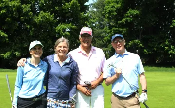 2 ladies and 2 men in a golf foursome smiling together