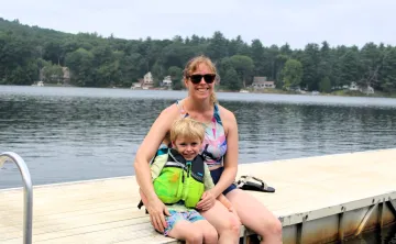 mother and son sitting on dock at Camp Frank A. Day during WSYMCA Family Camp weekend