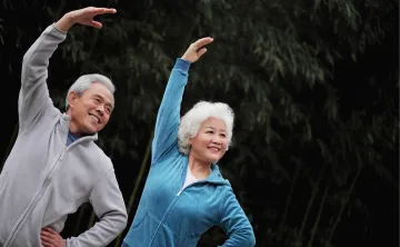 2 people stretching with their arm up