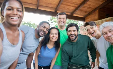 group of adults outside smiling