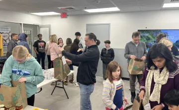 group of volunteers packing meal kits at the wells ave ymca