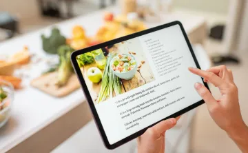 recipe on an ipad in a kitchen with food prep out on counter