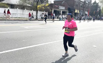 Liz Puleo running the 2025 Boston Marathon for the WSYMCA