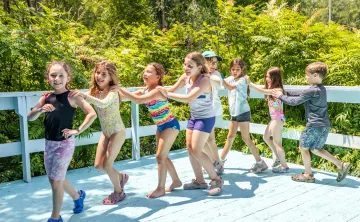 Camp Chickami campers having fun dancing in a line together