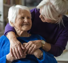 Two people smiling and hugging