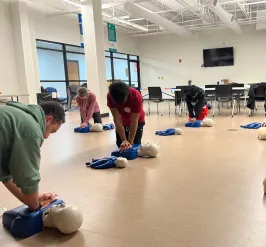 A class learned how to perform chest compressions on dummies.