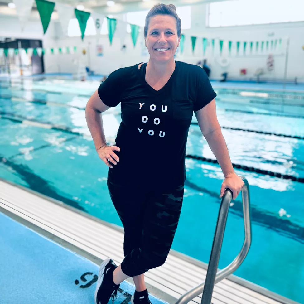 Jenny Dalton Hill smiles beside the indoor pool.