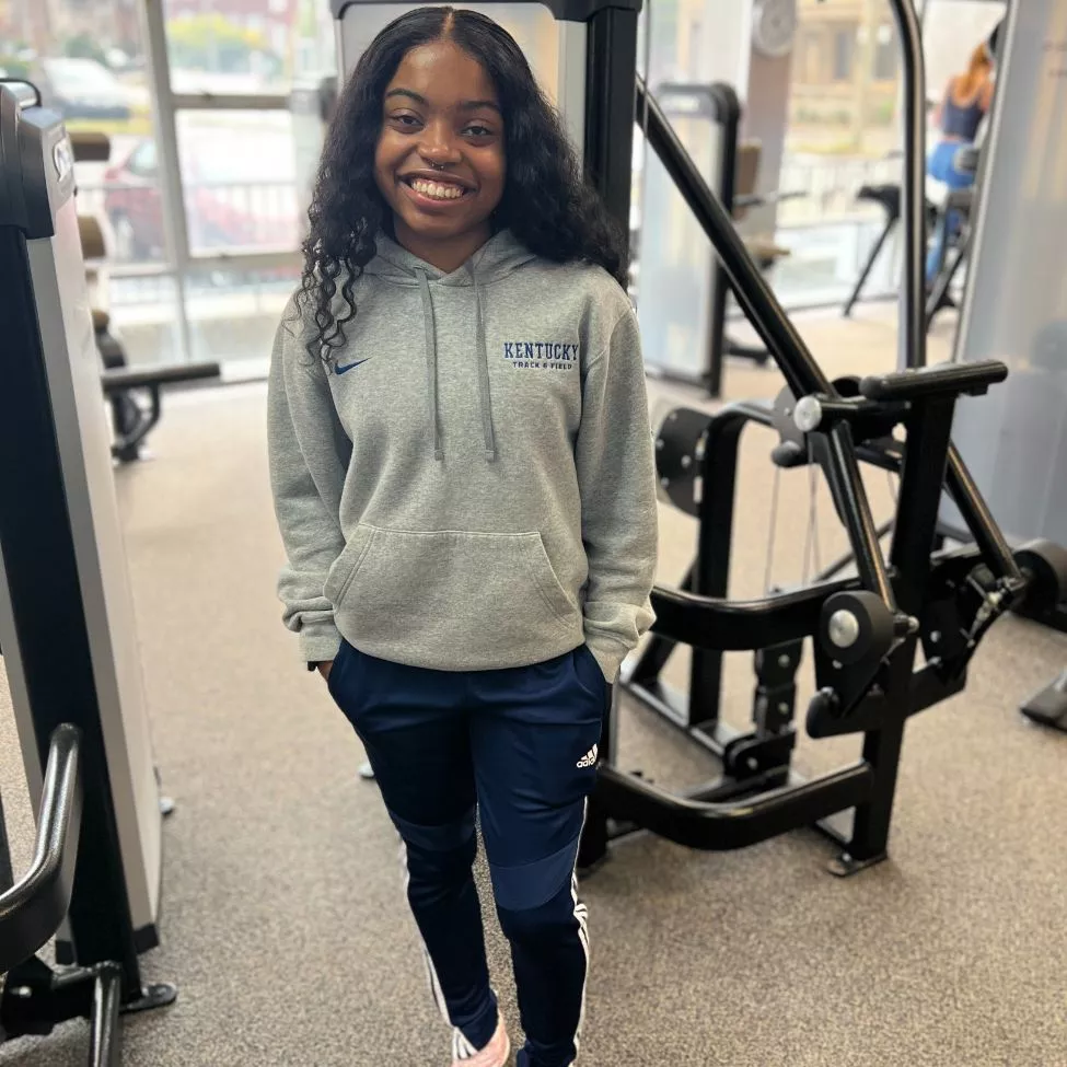 Intern Bryanna smiles on the wellness floor at the High Street YMCA