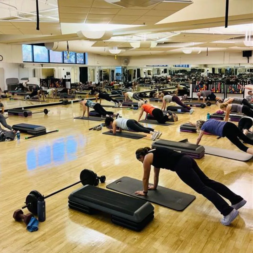 A group exercise class at the YMCA of Central KY holds a plank