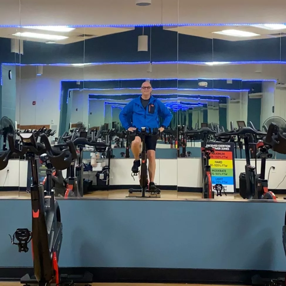 Indoor cycling instructor Dan S prepares for class on his bike.
