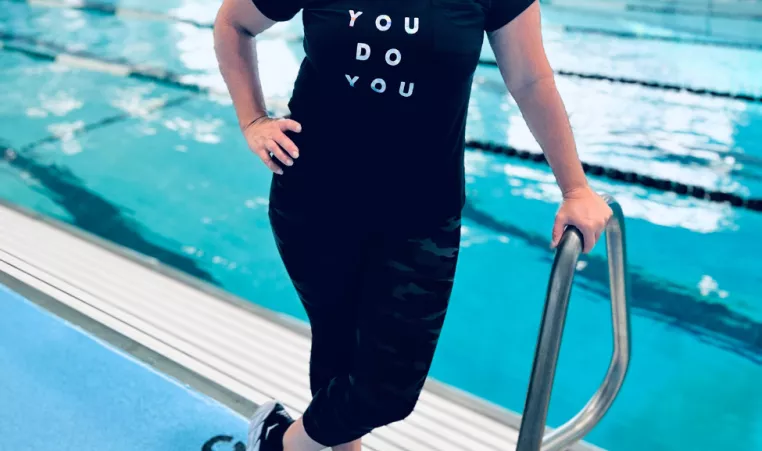 Jenny Dalton Hill smiles beside the indoor pool.