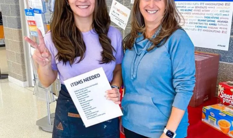 Dana and Connie collect food at the Whitaker Family Y for families on winter break.