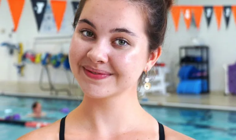 Senior swimmer Linden M smiles at the North Lexington YMCA indoor pool