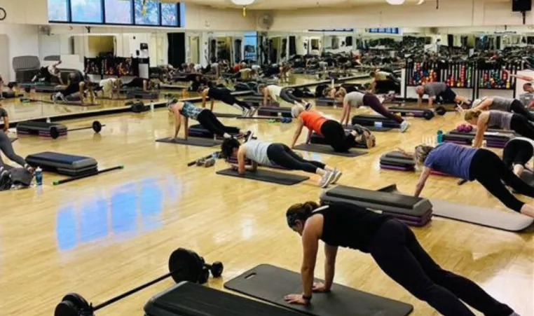 A group exercise class at the YMCA of Central KY holds a plank