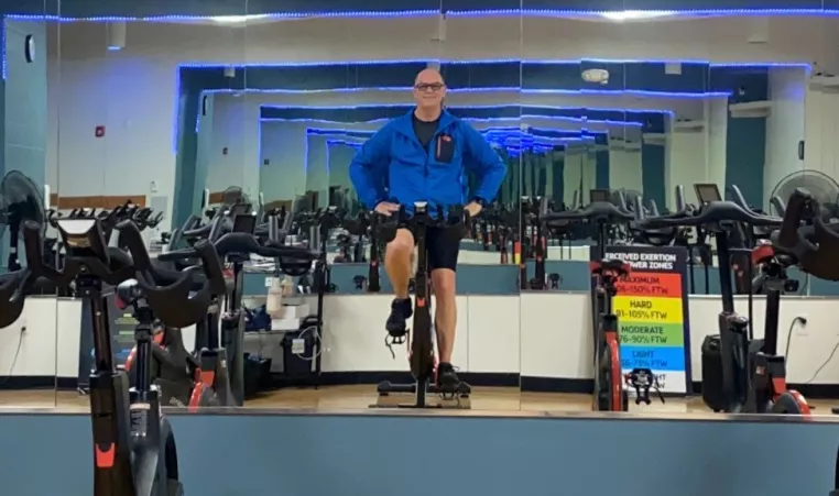 Indoor cycling instructor Dan S prepares for class on his bike.