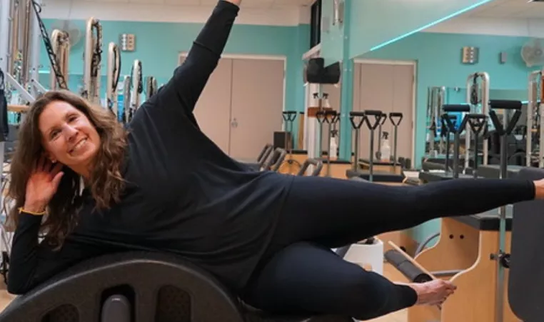 An instructor at the YMCA of Central KY demonstrates Pilates Reformer