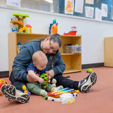 A YMCA employee cares for an infant. 