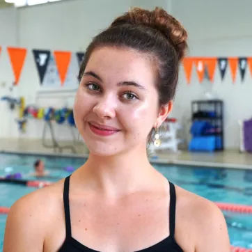 Senior swimmer Linden M smiles at the North Lexington YMCA indoor pool