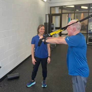 Personal Trainer supervises a client getting stronger at the YMCA of Central Kentucky