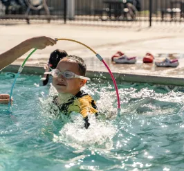 Child swimming through hoop