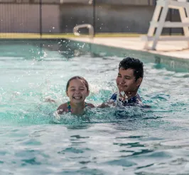 Child swimming with swim instructor
