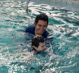 child taking swimming lessons