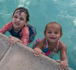 children in the pool smiling