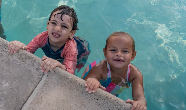 children in the pool smiling