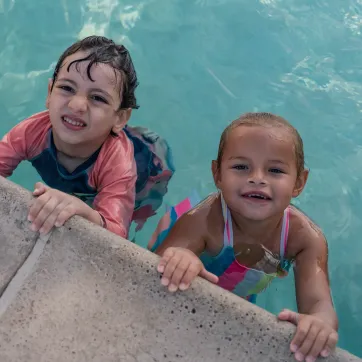 children in the pool smiling