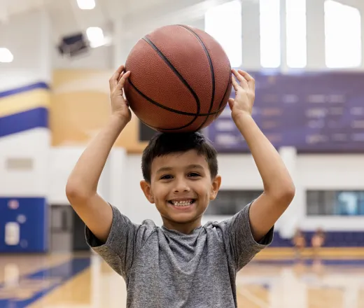 Boy in Gym Holding Basketball