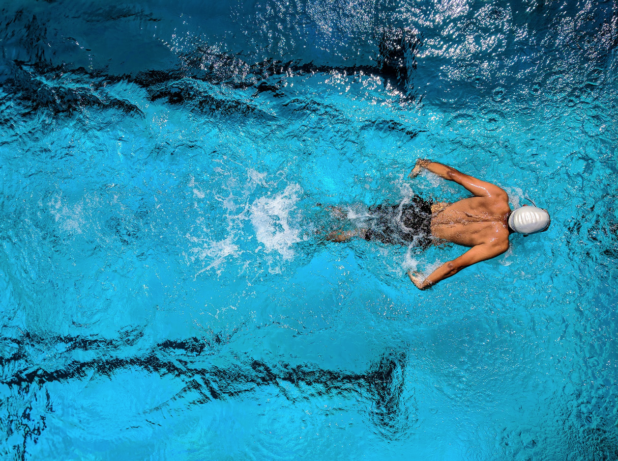 aerial view of swimmer doing butterfly stroke in a pool
