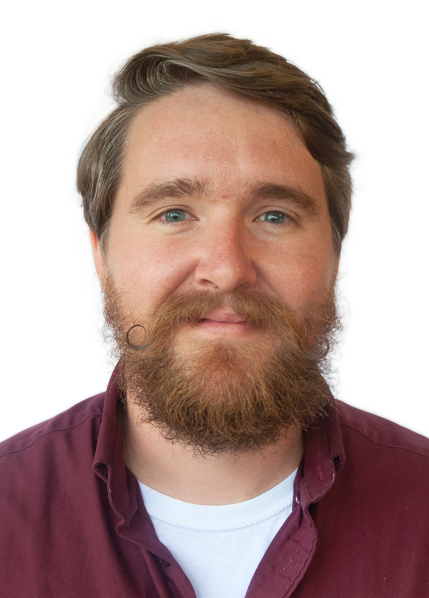 a headshot of a man with a reddish brown beard.