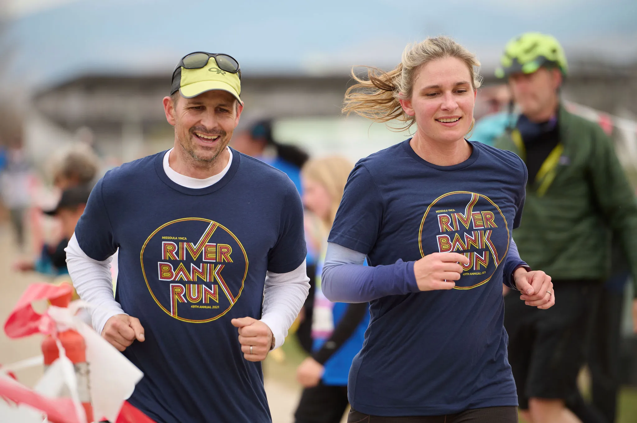 couple running a race and smiling