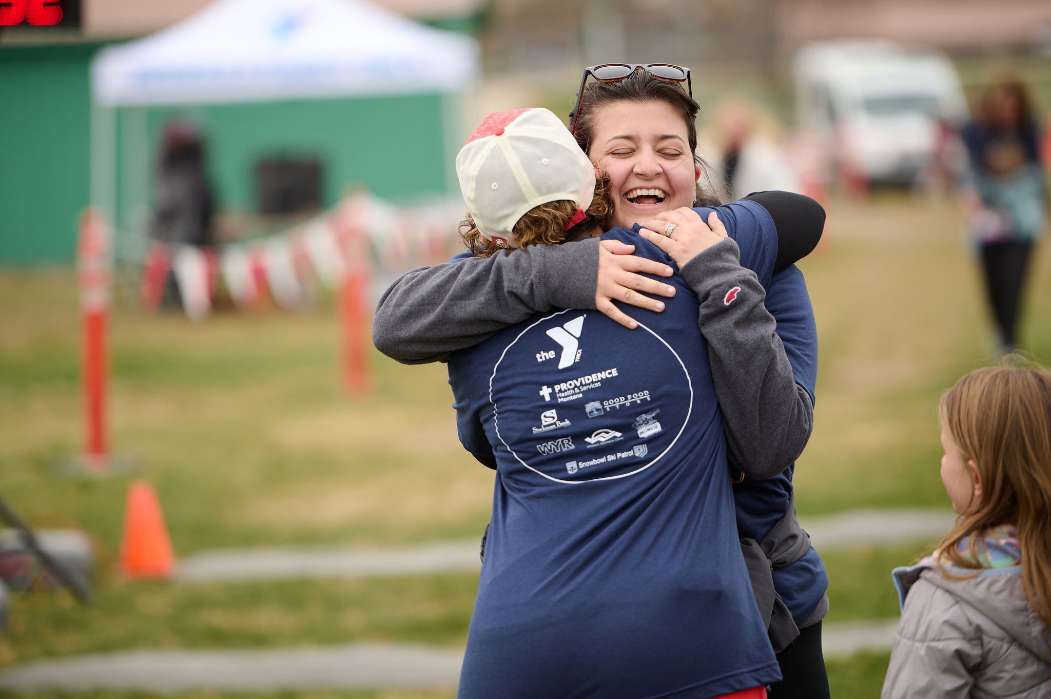 two friends hug after finishing a running race
