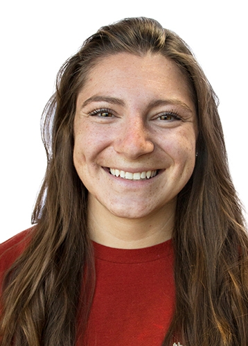 a headshot of smiling woman in a red shirt
