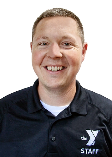 man with short blonde hair wearing a black polo shirt with a ymca logo