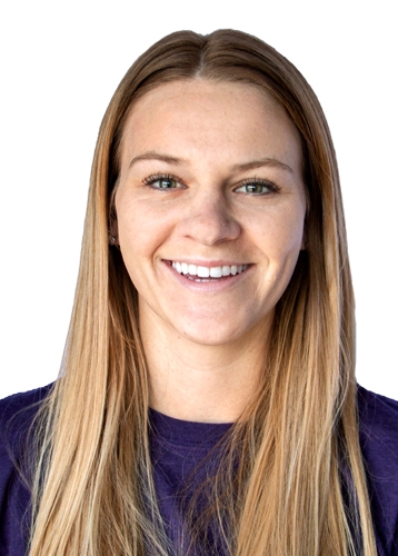 professional portrait of a woman with long blonde hair and a purple t-shirt