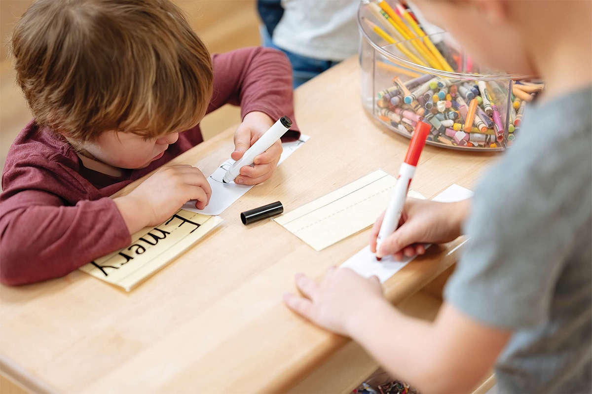 child coloring at a desk