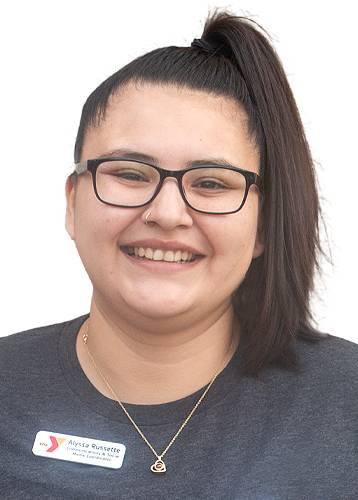 headshot of a smiling woman with glasses and brown hair pulled into a high ponytail. she is wearing a grey shirt and a white ymca name tag.