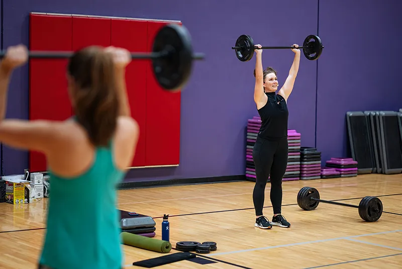 Women holding barbell above her head