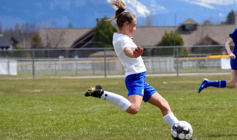 Chloe Taulbee kicks a soccer ball during a game 